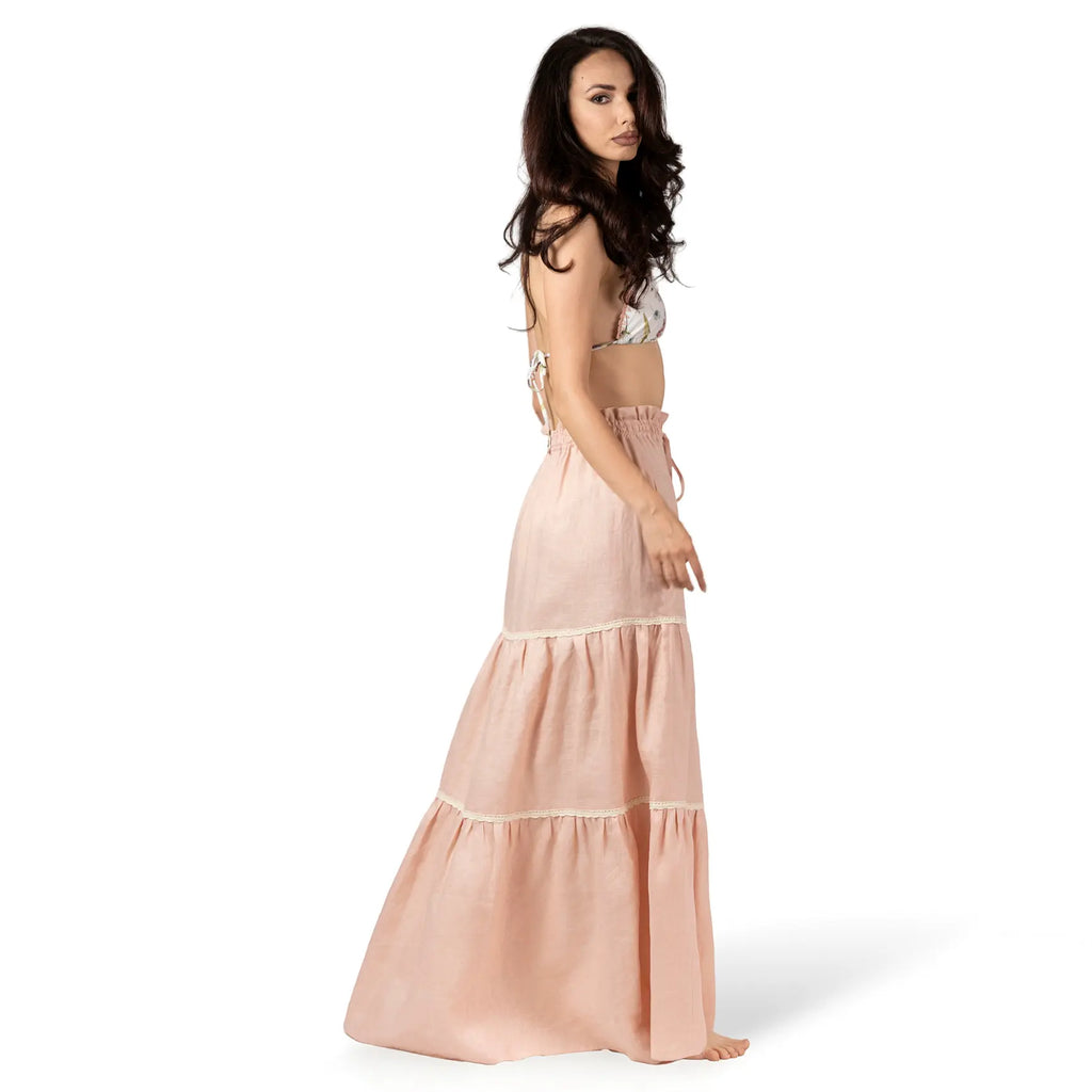 ALURE PEACH Linen Long Skirt by BILEYA COUTURE crafted from 100% natural linen, featuring a flowing three-tiered silhouette, crochet lace details, elasticated waistband, and elegant maxi length for luxury designer resort wear styling.
