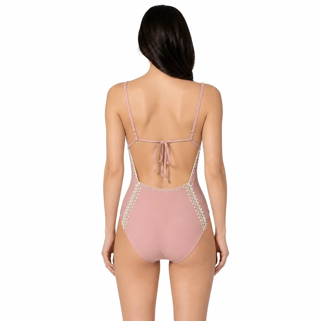 Pink swimsuit with lace details on a white background