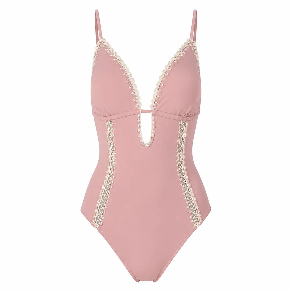 Pink swimsuit with lace details on a white background