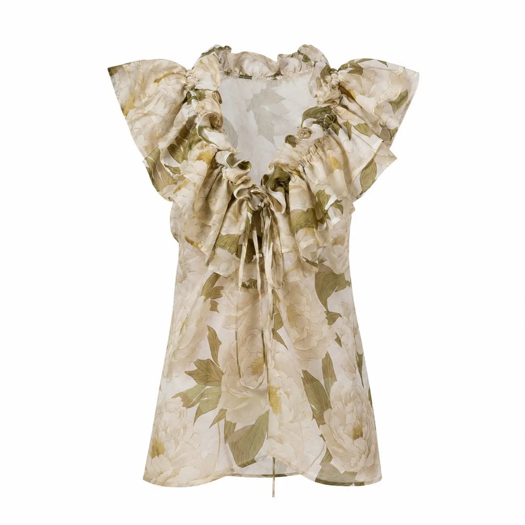 FLEUR DE LUMIÈRE Sleeveless Top by BILEYA COUTURE crafted from luxurious silk-cotton chiffon, featuring a romantic white peony floral print, voluminous ruffle neckline, adjustable front ties, and an elegant designer resort wear silhouette on a white background.