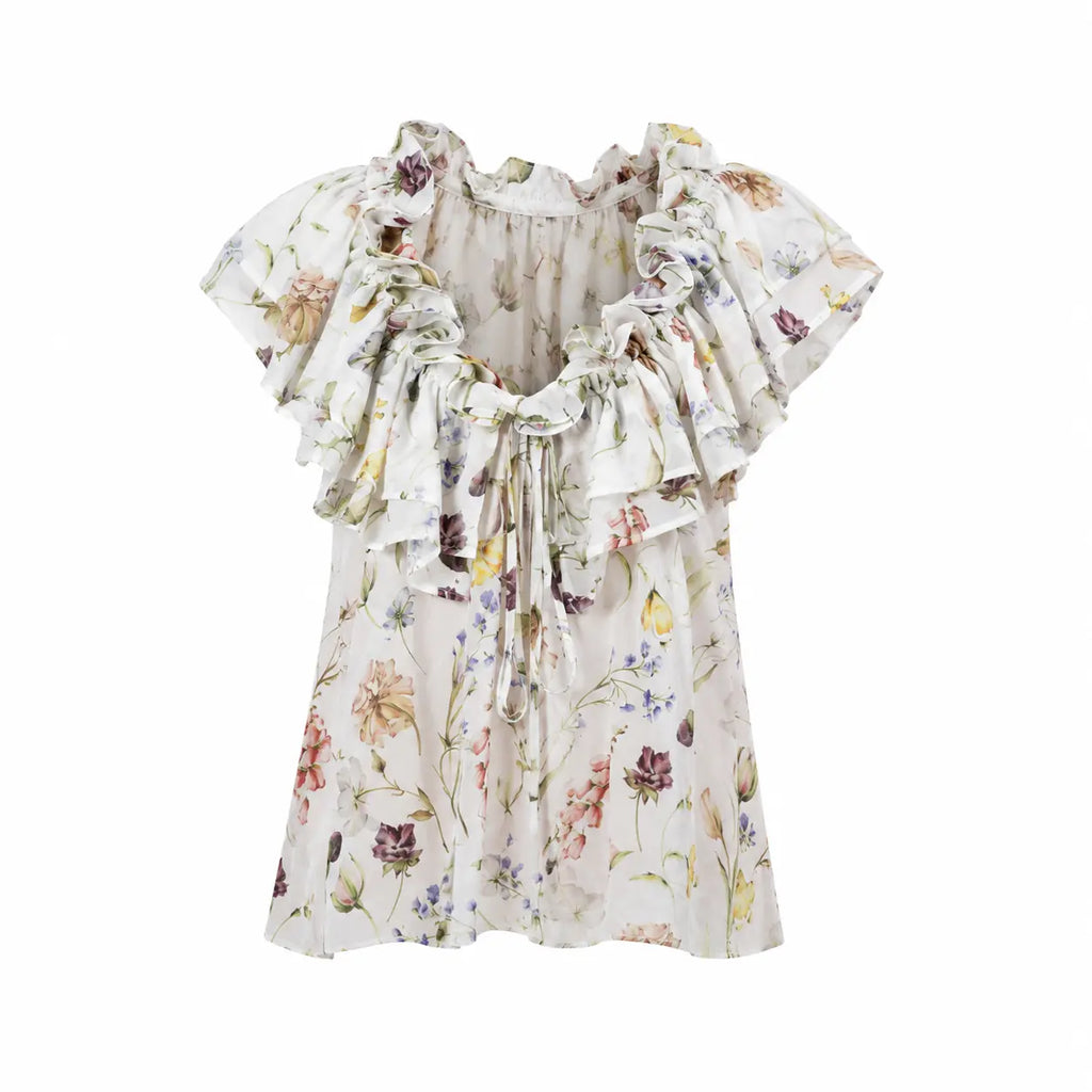 JARDIN White Sleeveless Resort Top by BILEYA COUTURE in floral silk chiffon with ruffle neckline on white background