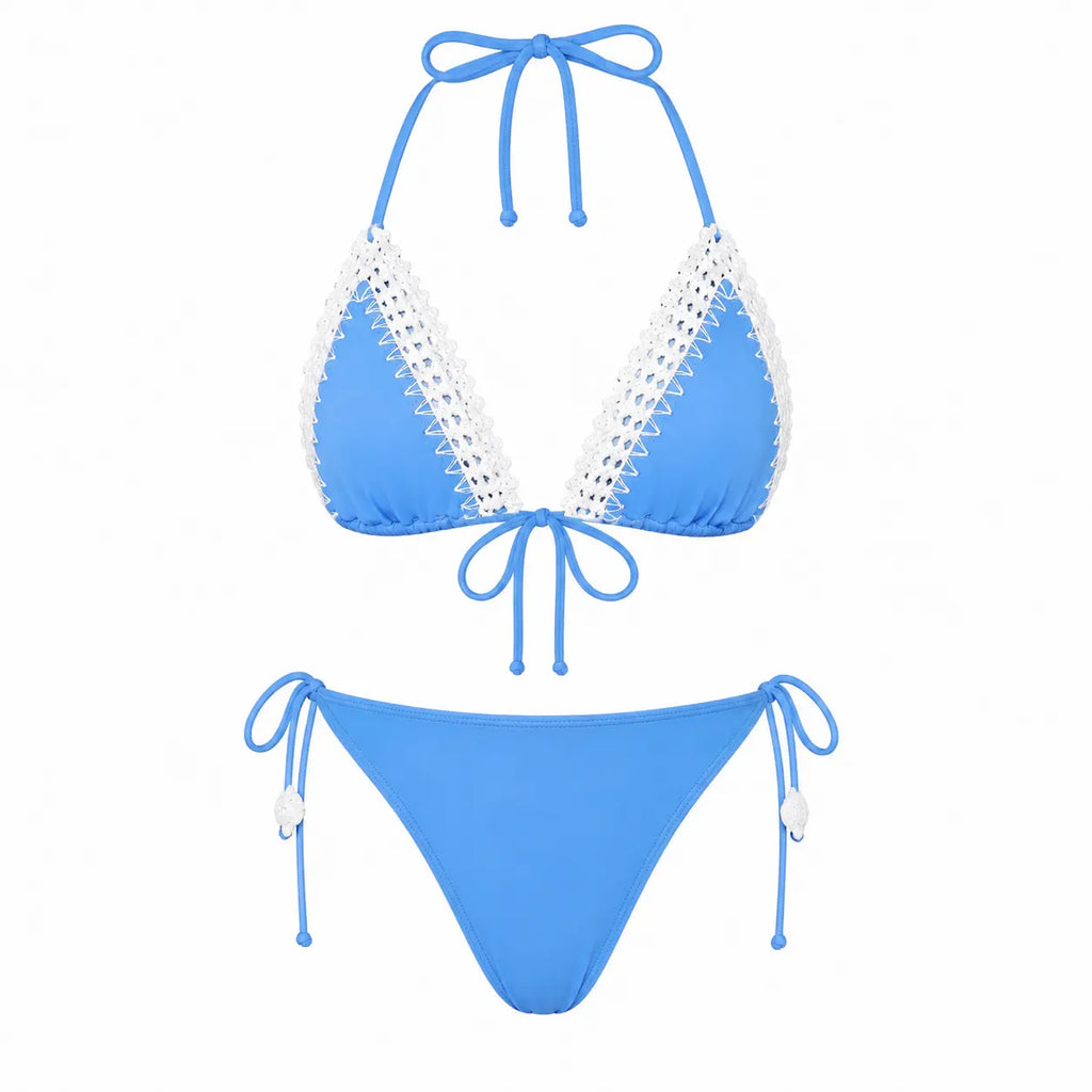 Blue bikini set with white lace details on a white background