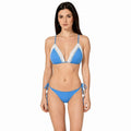Woman wearing a blue bikini with white lace details by bileya couture