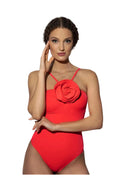 Woman wearing a red swimsuit with a floral design on a white background