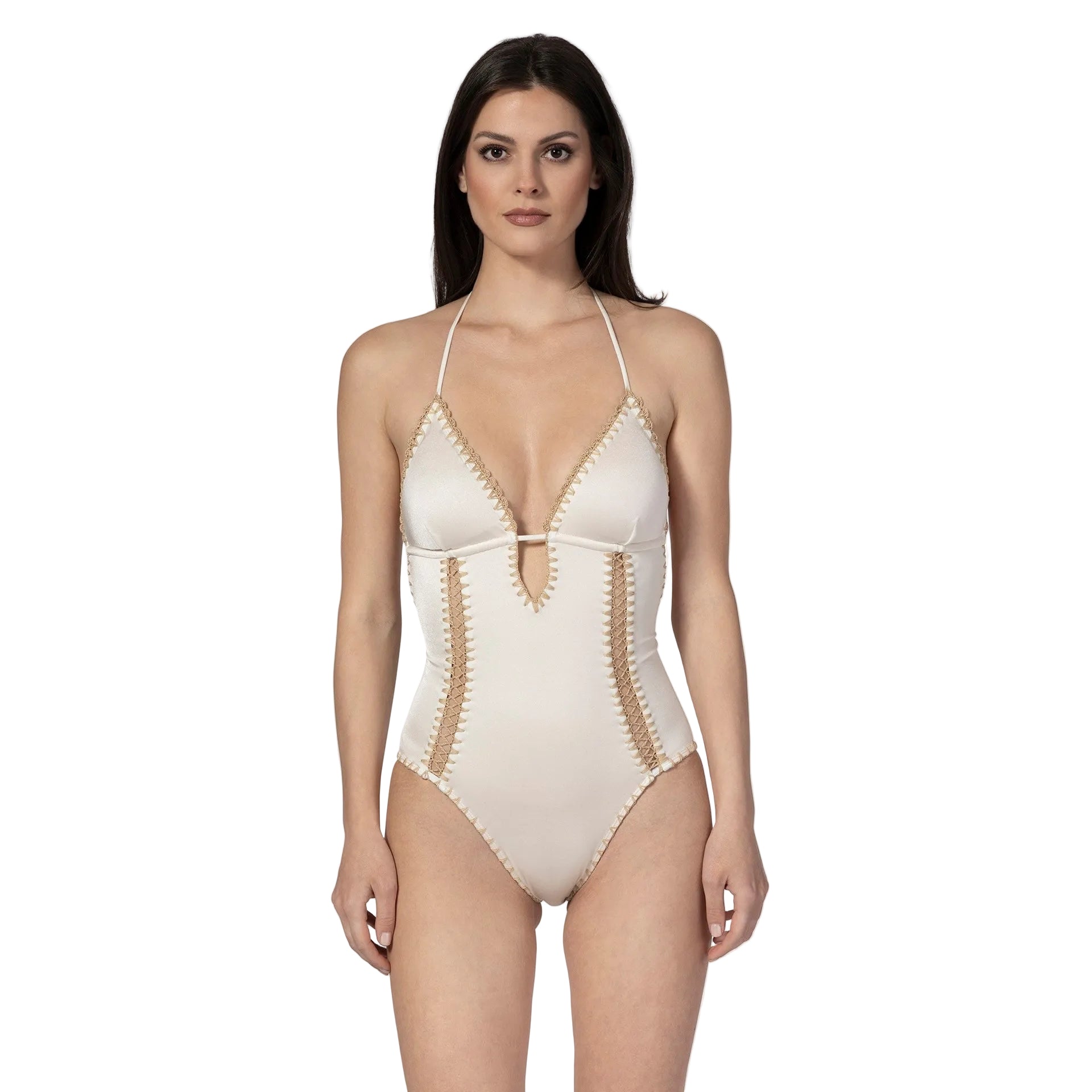 Woman wearing a white swimsuit with gold trim on a white background