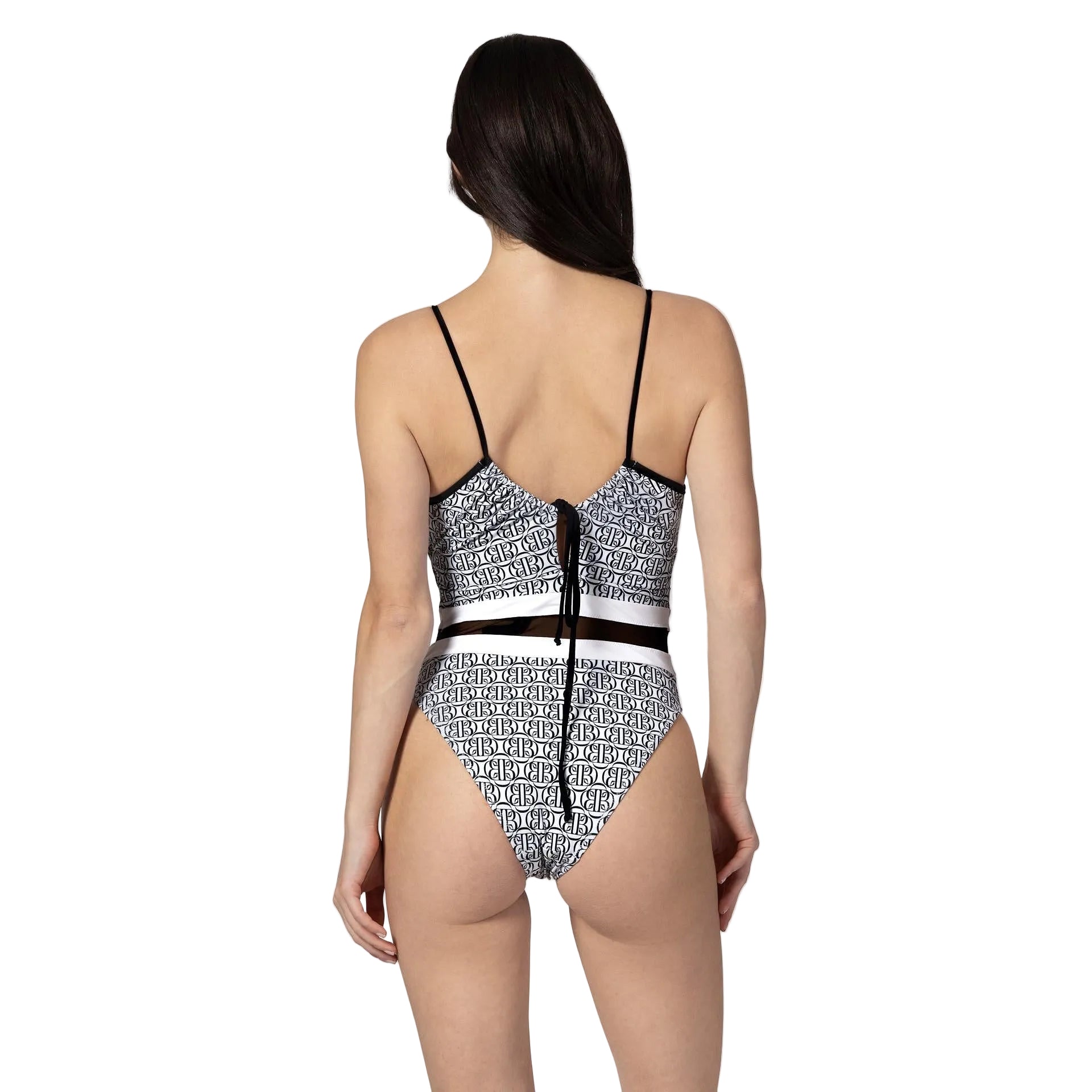 Woman wearing a black and white patterned swimsuit on a white background
