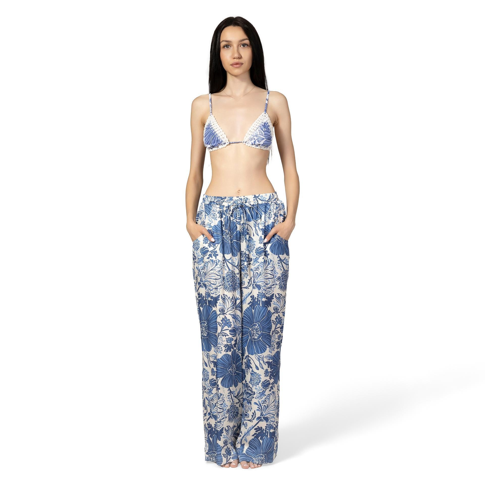 Woman wearing a blue floral bikini set on a white background