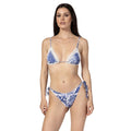 Woman wearing a blue and white patterned bikini on a white background