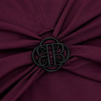 DONNA BURGUNDY detail by BILEYA COUTURE – rich burgundy fabric with black metal logo and luxury designer finish